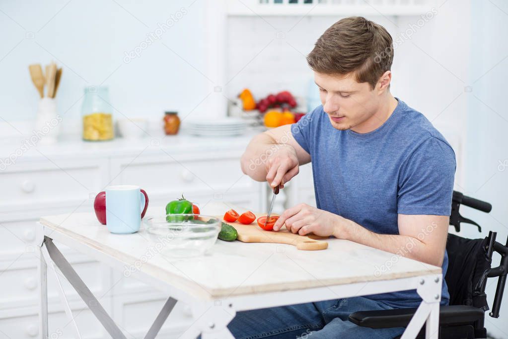 Concentrated brunette male being in the kitchen