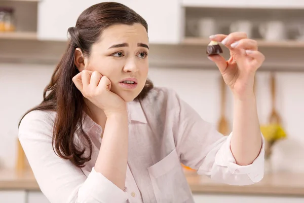 Triste mujer insatisfecha examinando dulces — Foto de Stock