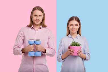 Cheerful couple posing with dumbbells and flower pot clipart