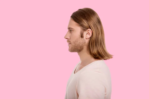 Side view of handsome man against pink background — Stock Photo, Image