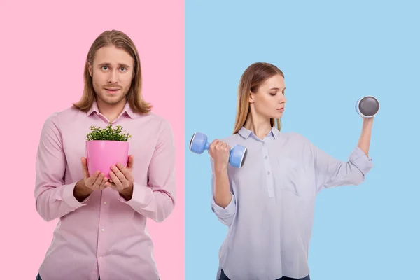 Young woman exercising with dumbbells and man holding flower pot — Stock Photo, Image