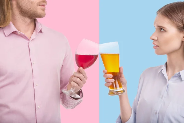 Close up of couple clinking glasses of wine and beer — Stock Photo, Image