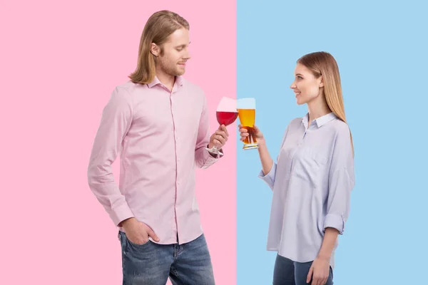 Young woman preferring beer while husband enjoying wine