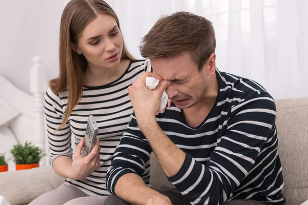 Emotional man crying while sitting with his woman — Stock Photo, Image