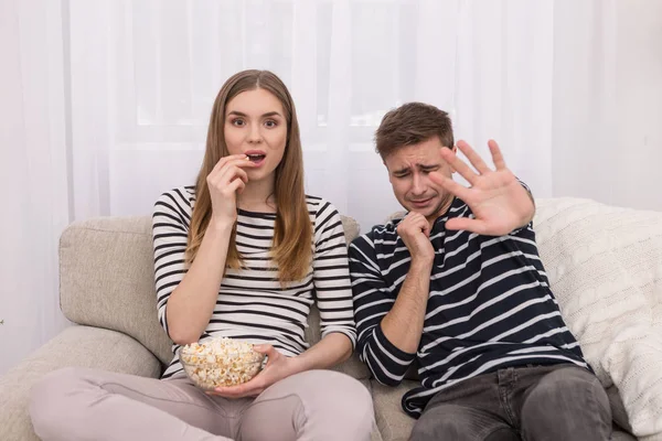 Scared young man afraid of the film — Stock Photo, Image