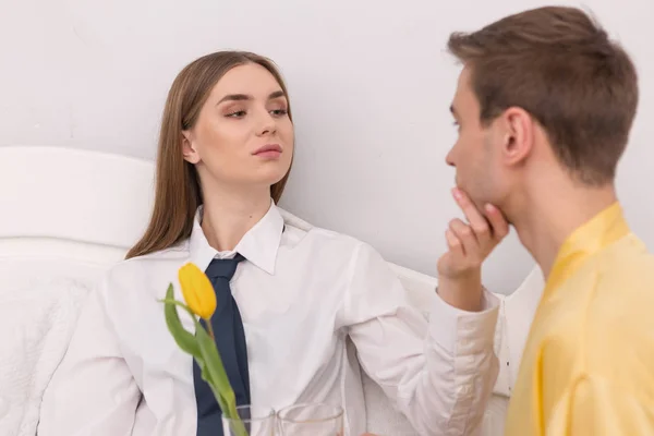 Determined woman caressing her house husband — Stock Photo, Image