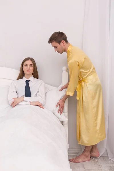 Cuidando novio haciendo su mujer cómoda en la cama —  Fotos de Stock