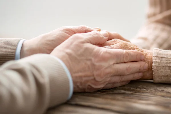 Nice senior man touching his wifes hands — Stock Photo, Image