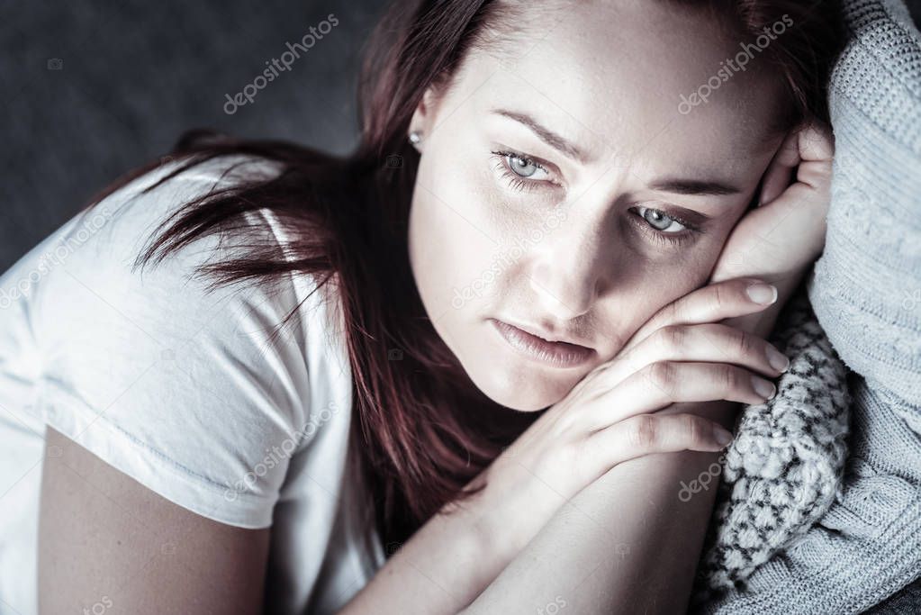 Upset unsettled woman resting on pillow