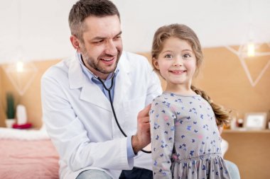 Kızlar kalp atışlarını dinlerken mutlu pratisyen