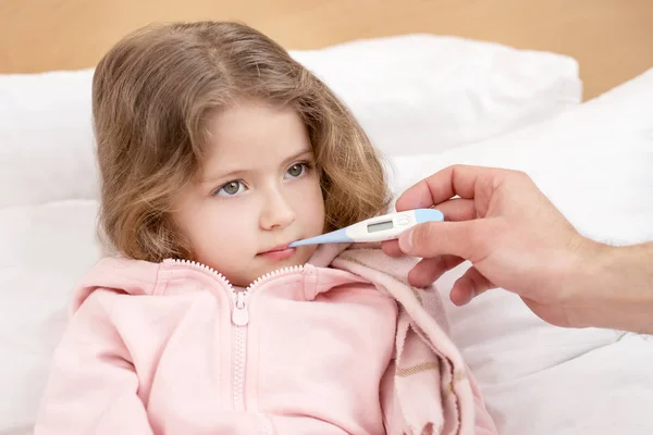 Bedårande barn har en termometer i munnen — Stockfoto