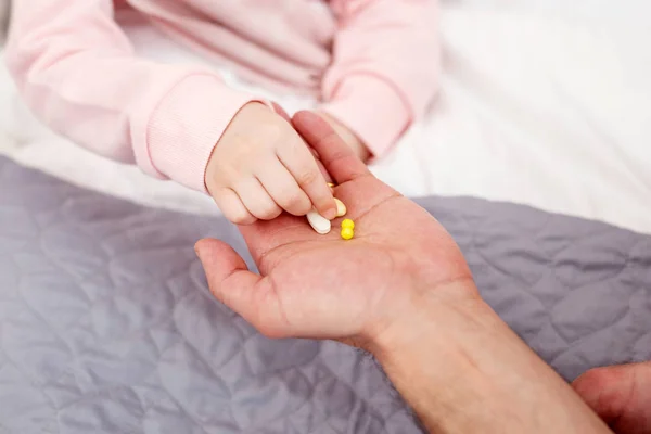 Sick girl taking pills for recovery — Stock Photo, Image