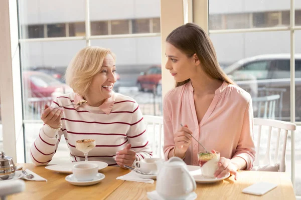 Joyful granny and granddaughter talking while having lunch — Stock Photo, Image