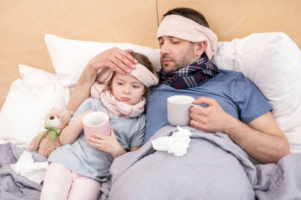 Unhealthy girl and daddy having a cold 