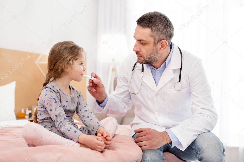 Determined young doctor examining a girl