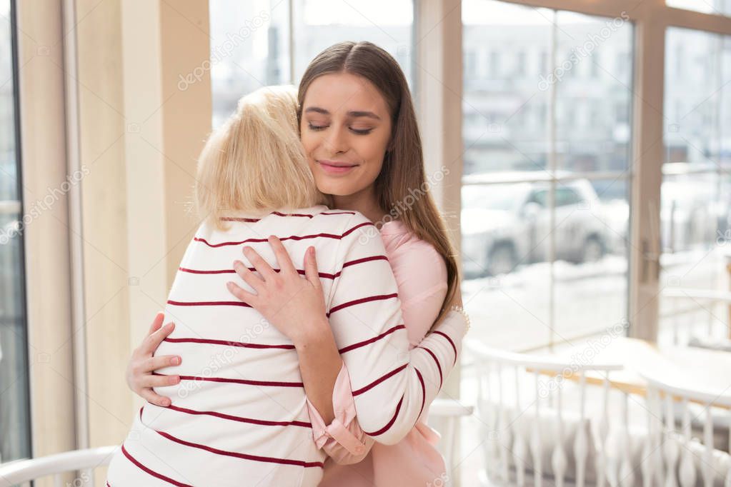 Loving girl hugging her granny