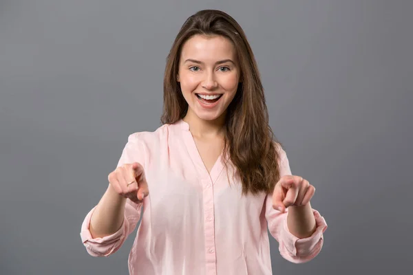 Nice happy woman standing against grey background — Stock Photo, Image