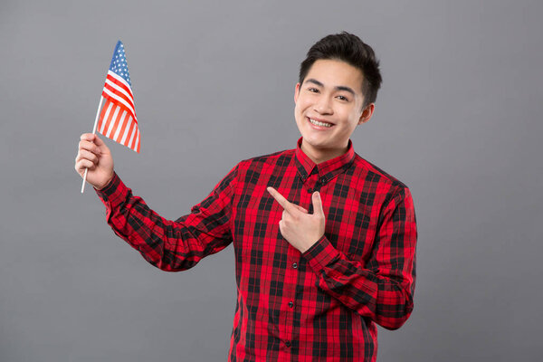 Delighted pleasant man showing the US flag
