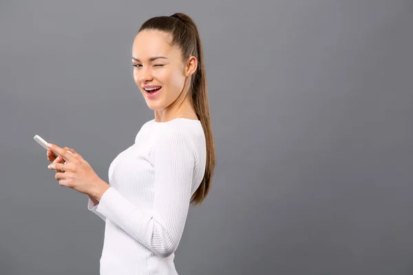 Cheerful positive woman winking to you — Stock Photo, Image