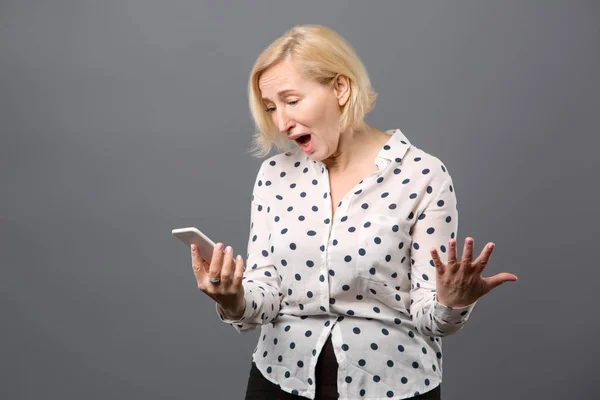 Nice excited woman looking at her phone screen — Stock Photo, Image