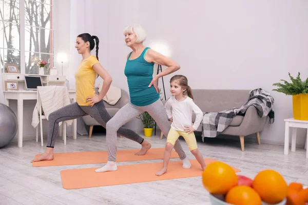 Happy sporty family exercising together — Stock Photo, Image