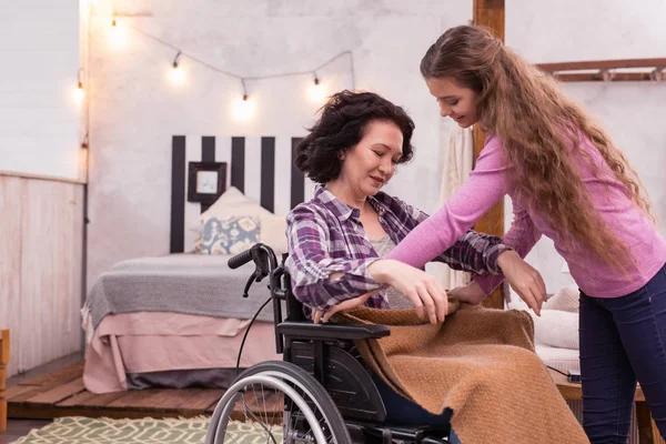 Beautiful girl proposing blanket to crippled woman — Stock Photo, Image