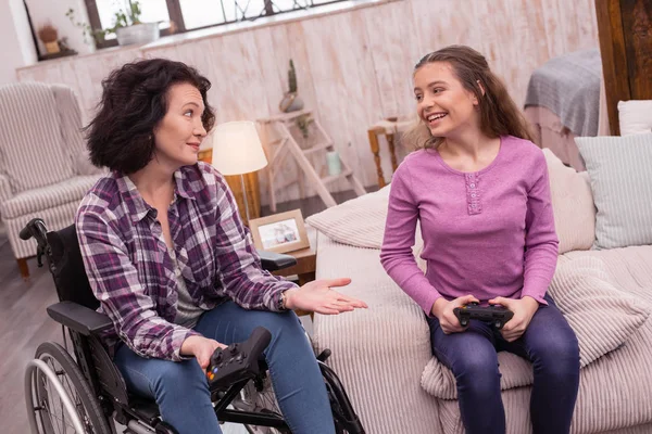 Jovial incapacitated woman and girl trying video gaming — Stock Photo, Image
