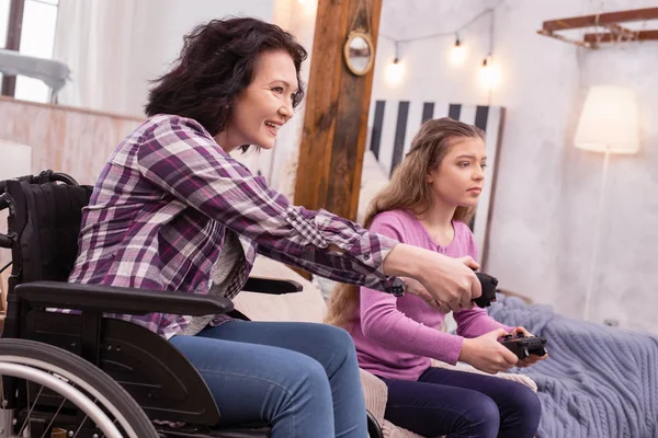 Exuberant incapacitated woman and girl gaming — Stock Photo, Image