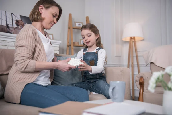 Inspired girl holing artificial brains with her mom