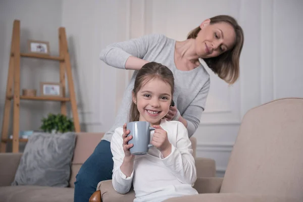 Liefdevolle moeder haar dochters haren kammen — Stockfoto