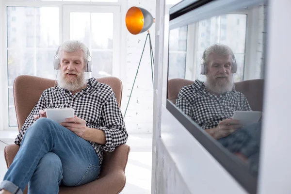 Bonito homem sênior assistindo filme no tablet — Fotografia de Stock