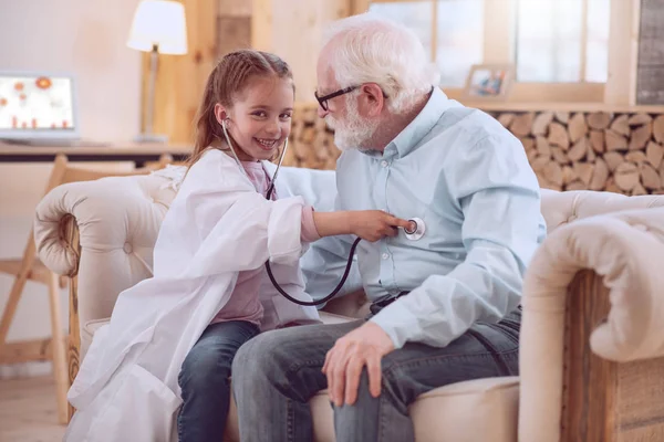 Positive happy girl using a stethoscope — Stock Photo, Image