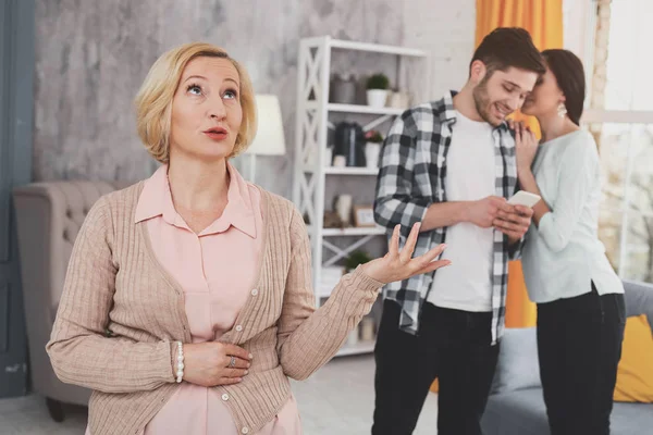 Sad unhappy woman standing near the married couple — Stock Photo, Image