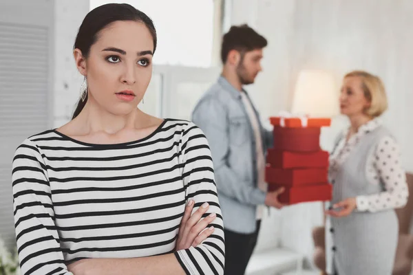 Unhappy young woman standing cross handed — Stock Photo, Image