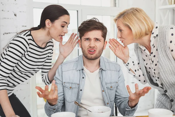 Unhappy moody man being in the centre of attention — Stock Photo, Image