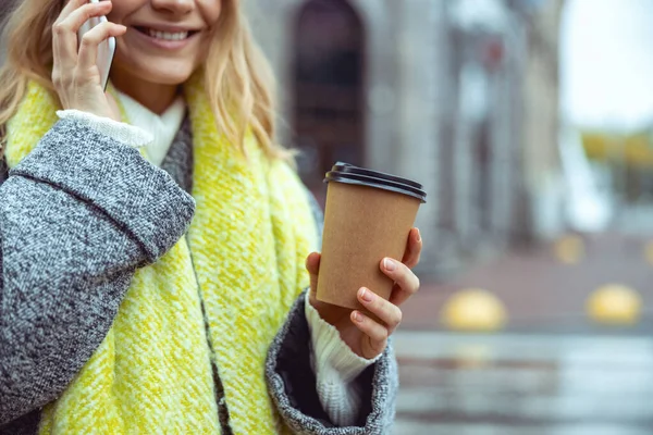 Pleased lady holding a paper cup in her hand — Stock Photo, Image