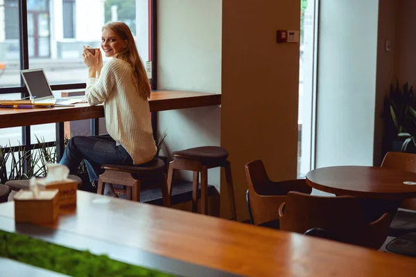 Trabalhador freelance feliz tomando chá pela janela — Fotografia de Stock