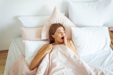 Charming young brunette female turning her head to window