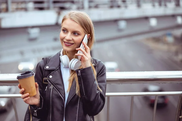 Menina com fones de ouvido nos ombros olhando para longe — Fotografia de Stock