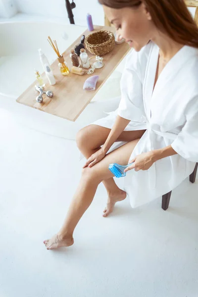 Top view picture of pretty girl that massaging her legs — Stock Photo, Image