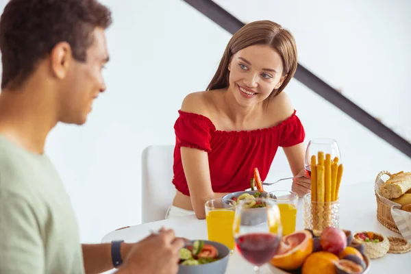 Cute long haired brunette looking at her boyfriend — Stock Photo, Image