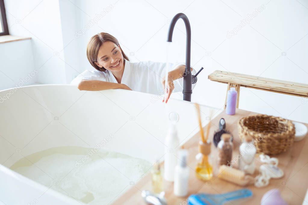 Positive delighted young female looking at water
