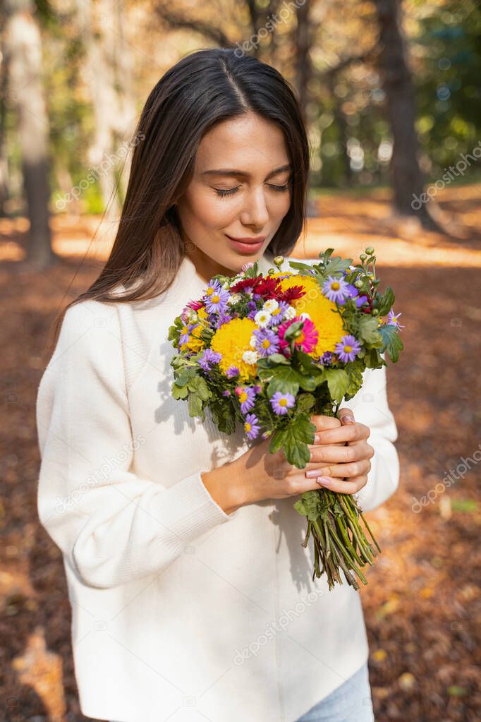 Beautiful smiling woman is enjoying beautiful bouquet