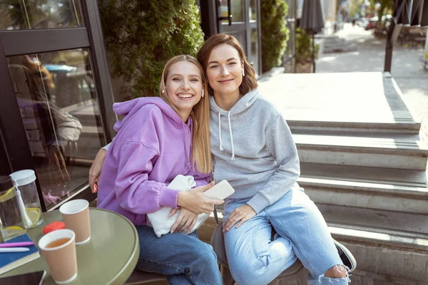 Positive delighted young females looking at camera — Stock Photo, Image
