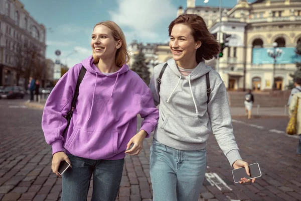 Veselé mladé ženy procházející se po městě — Stock fotografie