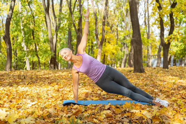Pleased fit woman in a yoga pose — Stock Photo, Image