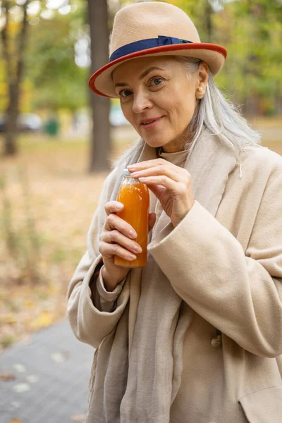 Female with a bottle of orange juice — Stock Photo, Image