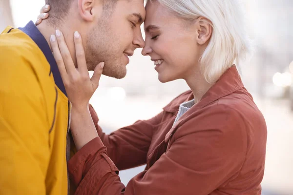 Young people being happy holding each other close — Stock Photo, Image