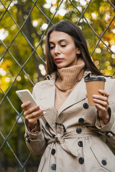 Young long-haired girl staring at her gadget — Stock Photo, Image