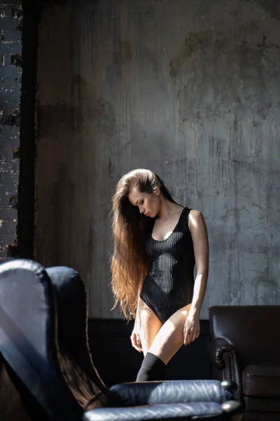 Beautiful girl with long hair in black bodysuit — Stock Photo, Image